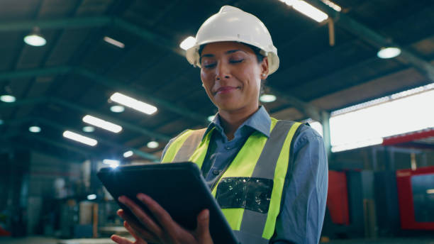 istock Employee, engineering and woman with a tablet, smile and internet with connection, typing and website information. Person, electrician and worker with technology, helmet and network with digital apps 1676137823