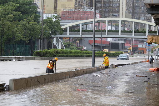 2023 Sept 8,Hong Kong.After heavy rain in Hong Kong, flooding occurred on Lung Cheung Road in Wong Tai Sin. Workers cleared the blocked streets as usual.