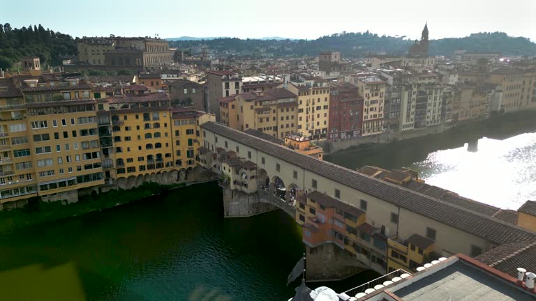Aerial view of ponte vecchio bridge in Florence city, Florence bridge and river, Historically and Culturally Rich Italian Town Florence, Firenze - Aerial view of the city of Florence, Popular tourist destination in the world