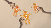 Poster. Contemporary art collage. Modern artwork in drawing style. Hands holding gingerbread men. Happy holidays are coming.