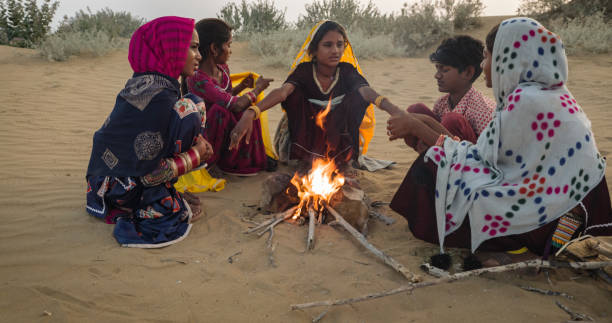 istock Indian kids setting up bonfire on sand dune 1676153454