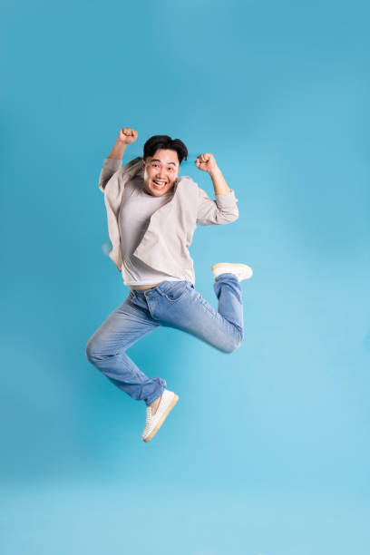 istock Full body image of Asian man posing on blue background 1676159385
