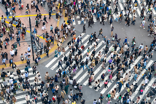 Tokyo, Japan-April 22, 2023;  High angle view of people on the crossing of Shibuya shopping district intersection just outside the train station