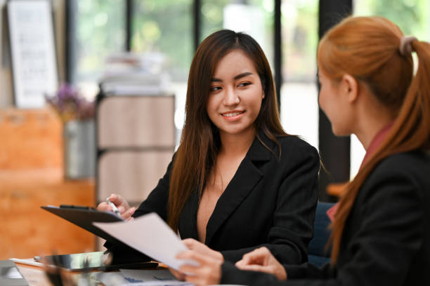 istock Two businesswoman working on work papers and discussing business data at modern office. 1676163537