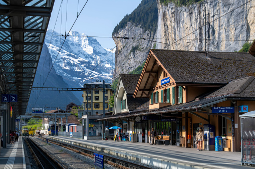 Lauterbrunnen, Switzerland-May 29, 2023; Platforms and train tracks of railway station where trains of connect Lauterbrunnen and Grindelwald with the Kleine Scheidegg and Jungfraujoch