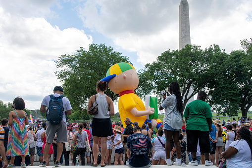 Washington DC, USA-July 4, 2023; Spectators watching the 4th of July parade with Washington Monument obelisk in background