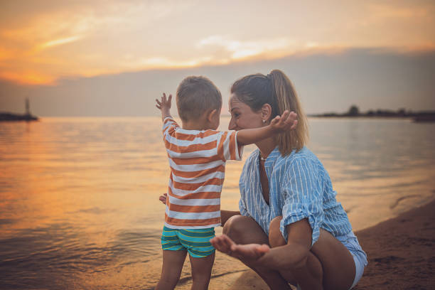 istock Mother with son on the beach 1676171759