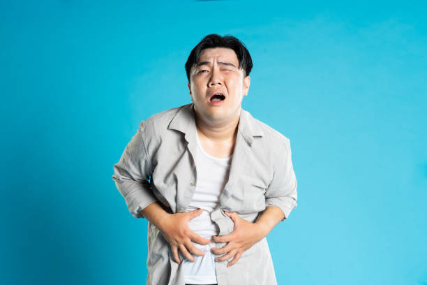 istock Image of Asian man having health problems, isolated on blue background 1676172916