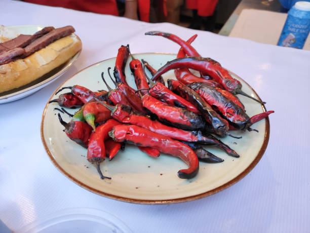 istock Red capsicum hot roasted pepper on  white plate 1676192657