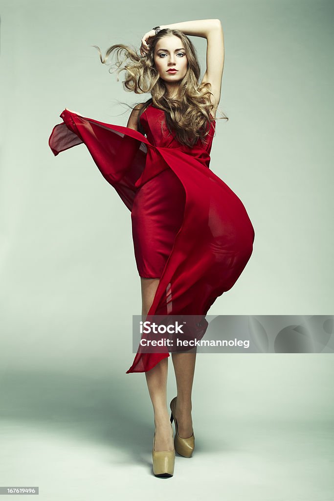 Fashion photo of young magnificent woman in red dress Fashion photo of young magnificent woman in red dress. Studio photo Women Stock Photo