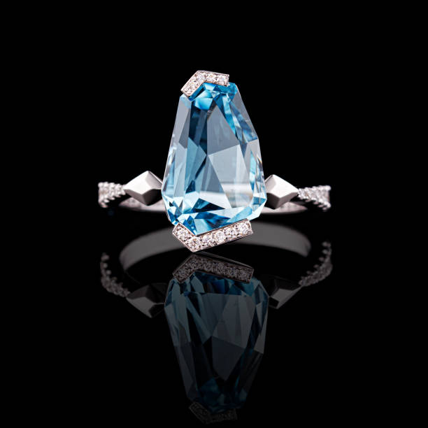istock beautiful white gold ring with diamonds and aquamarine on a black background 1676208645