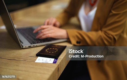 istock Woman with European Union passport is waiting for her flight. 1676212711