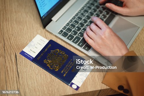 istock Woman with UK passport is waiting for her flight. 1676212736