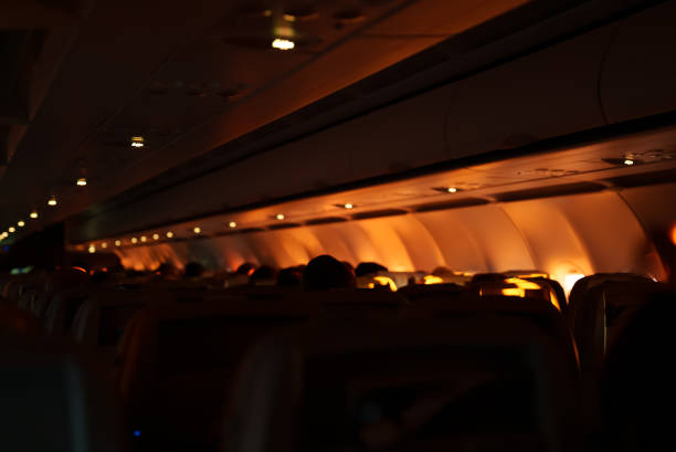 夜間飛行中の乗客と飛行機の内部。 - commercial airplane airplane cabin passenger ストックフォトと画像