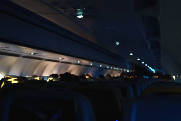 夜間飛行中の乗客と飛行機の内部。 - commercial airplane airplane cabin passenger ストックフォトと画像