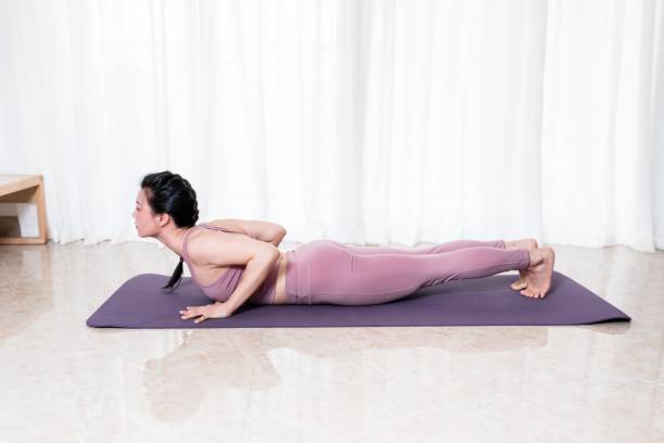 istock Woman doing yoga in bright home environment 1676225949