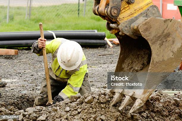 Construction Worker Digging Dirt Out With The Help Of Crane Stock Photo - Download Image Now
