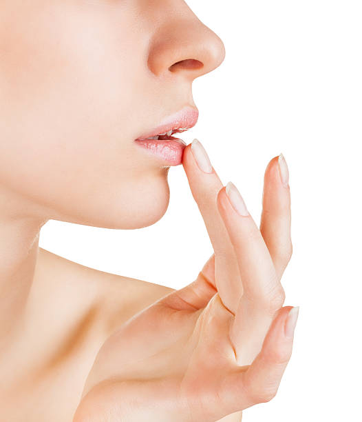 Woman applying lip balm on white stock photo