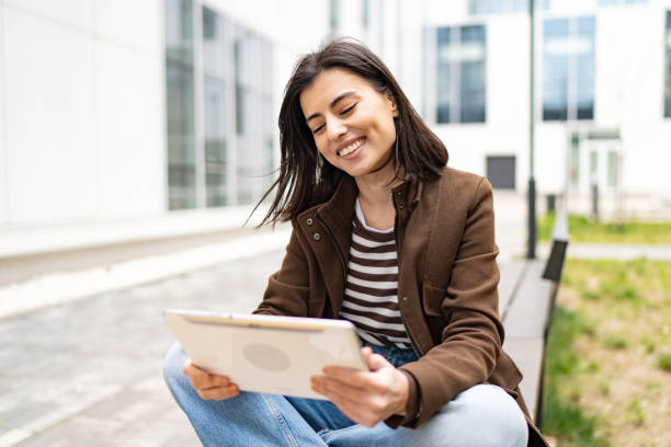 istock Happy young woman having a video call 1676255820