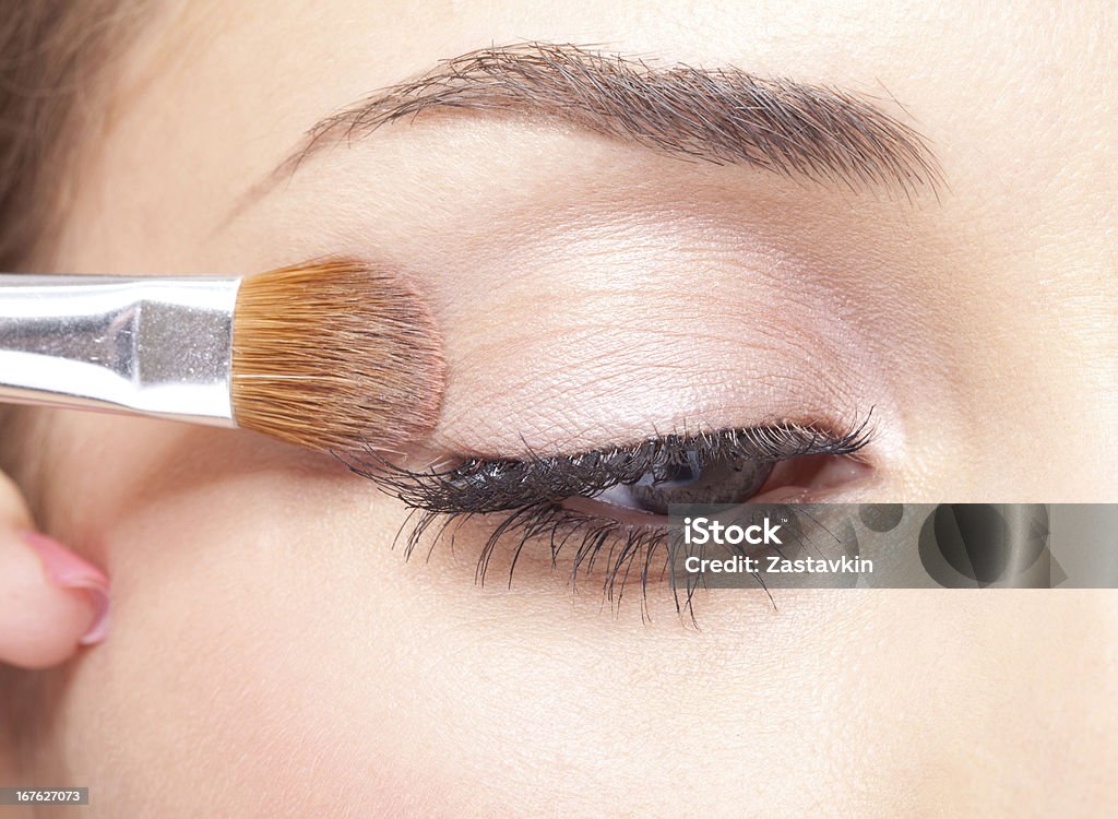 Eye makeup Young beautiful woman applying makeup eye shadows by brush 20-24 Years Stock Photo
