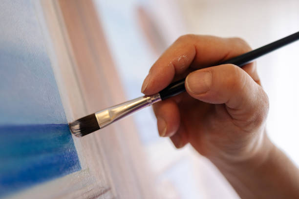 istock Close-up of a hand painting on canvas 1676273574