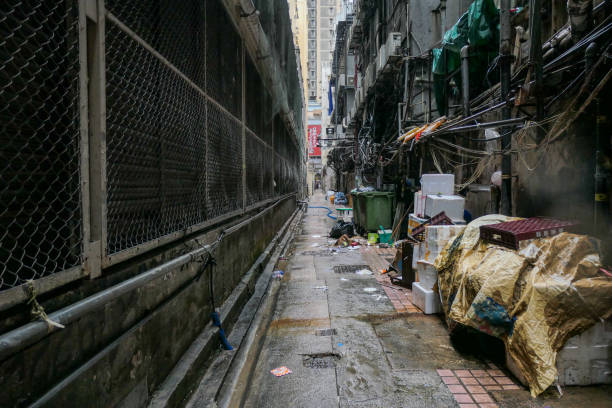 Chungking Mansions Alleyway Alleyway next to the Chunking Mansions building on Nathan Road, Tsim Sha Tsui, linking Nathan Road and Minden Row. This image was taken on an overcast and rainy afternoon on 8 September 2023. chinese slum stock pictures, royalty-free photos & images