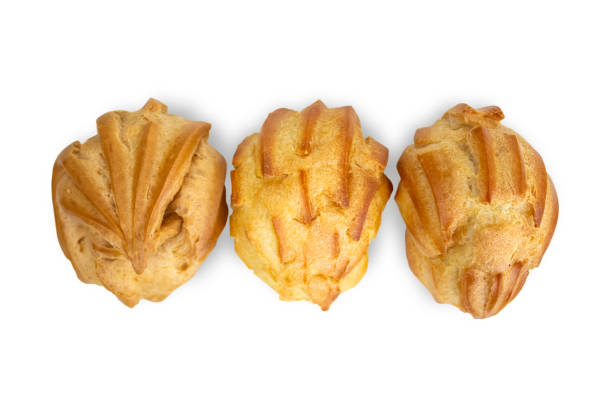istock Fresh pastries lying in a row (eclairs, profiteroles). 1676296195