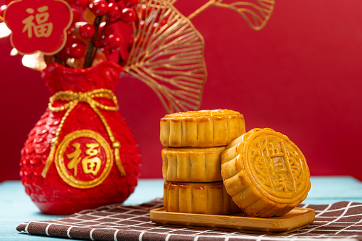 traditional mooncake with decorative vase horizontal composition the Chinese on the mooncake means five kernels and the ones on background means fortune.