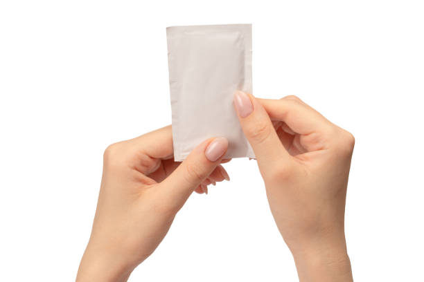 istock Wet wipe in a woman hand isolated on a white background. 1676307176