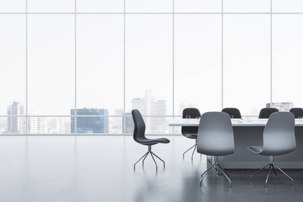 istock Modern meeting room interior with reflections on concrete flooring and panoramic window with city view and daylight. Commercial office concept. 3D Rendering. 1676308260