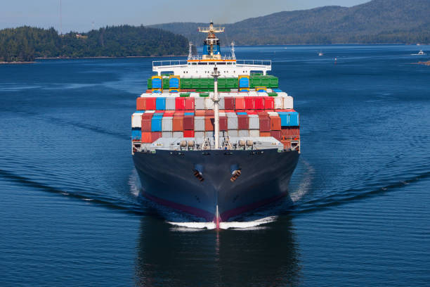 Container Ship Aerial photo of a large loaded container ship. boat front view stock pictures, royalty-free photos & images
