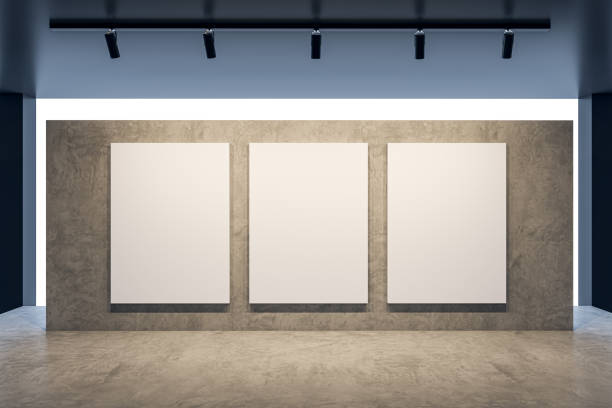 istock Modern concrete gallery interior with blank white mock up frames on wall. Art and display concept. 3D Rendering. 1676309338