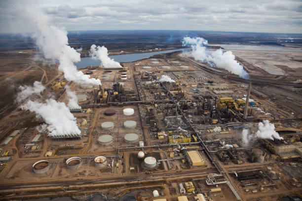 Oil Refinery A large oil refinery along the Athabasca River in Alberta's Oilsands.  Fort McMurray, Alberta. oilsands stock pictures, royalty-free photos & images