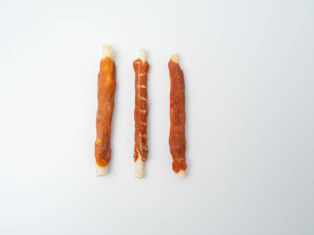 istock Dog chewing sticks on a white background. 1676312141