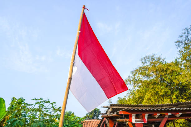 istock red white flag of Indonesia independence day, on blue sky background 1676314463