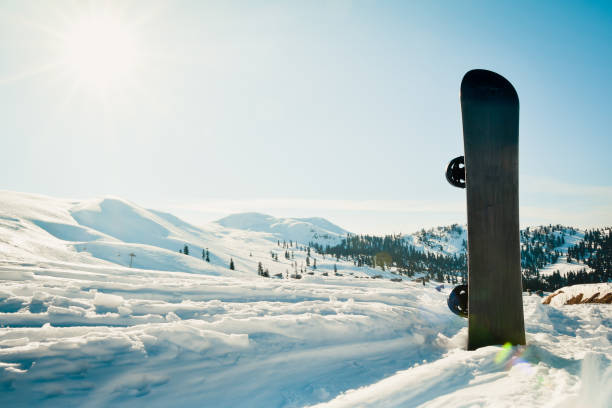 istock Black base snowboard in a snow with white mountains in the background. Goderdzi ski resort in Georgia 1676315568