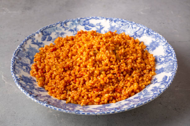 istock Traditional turkish bulgur pilaf with tomato sause in plate (Turkish name; meyhane pilavi) 1676323805