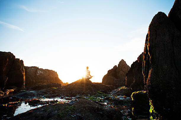 istock Female meditating on the rocks 167633029
