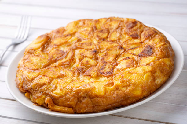 istock Spanish omelette with potatoes, typical spanish cuisine on gray concrete floor. Tortilla Espanola. Turkish name; Yumurtali patates 1676333591