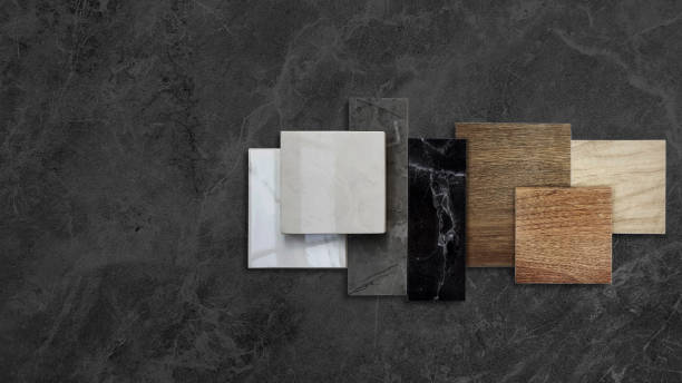 istock combination of interior material samples placed on dark black marble table including wooden ceramic floor tiles, luxury marble stones, elegance artificial stone tiles with blank space for design. 1676334107