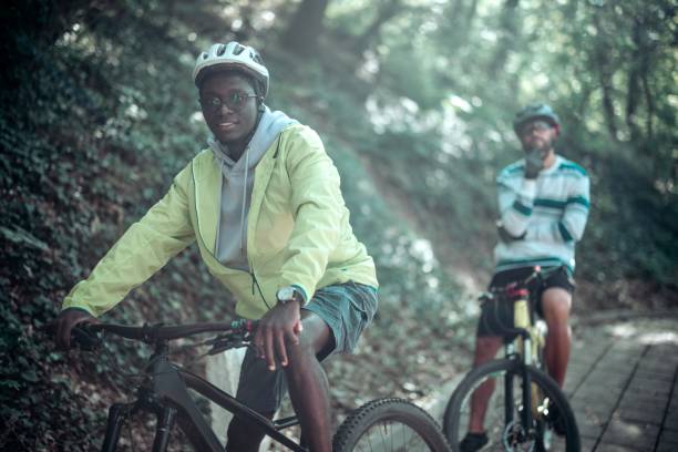 Portrait of multiracial men on bicycles in nature