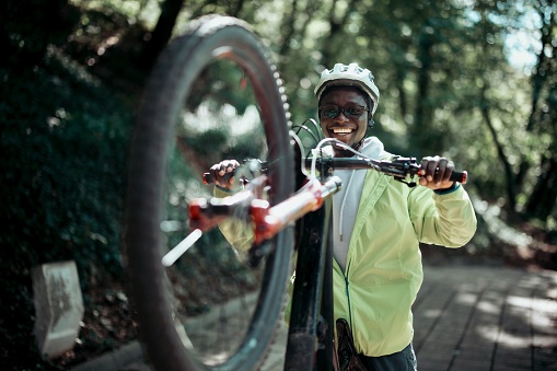 Portrait of a smiling and happy black man with a mountain bike