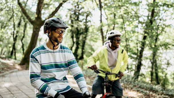 istock Close-up of two multiracial friends on bikes 1676349846