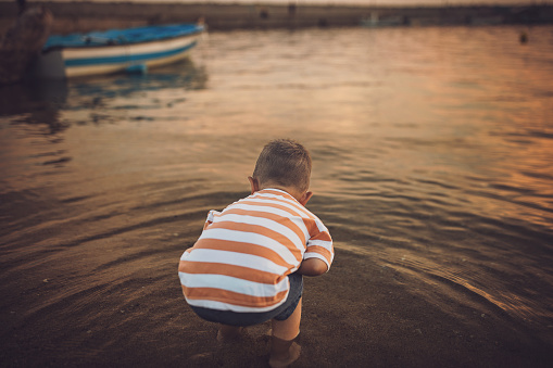 Little boy playing in the sea.