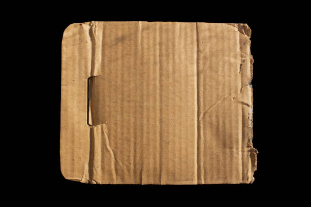 istock Torn cardboard paper piece isolated on a black background 1676355749