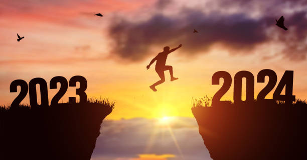 istock Man silhouette jumping on cliff 2023 over the precipice at amazing sunset. New Year's concept. Vector of starting and welcome happy new year 2024. People enters the year symbol 2024, creative idea. 1676359616