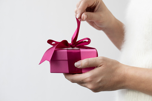 Woman holding gift box.