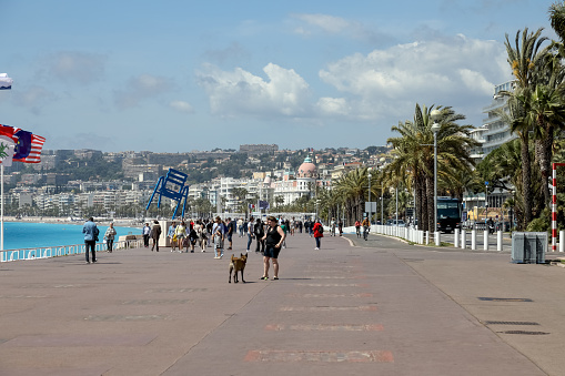 Nice, France - April 26, 2023: Seafront Promenade des Anglais is a perfect place for walking, cycling or any other form of relaxation for both tourists and residents who come here in large numbers.