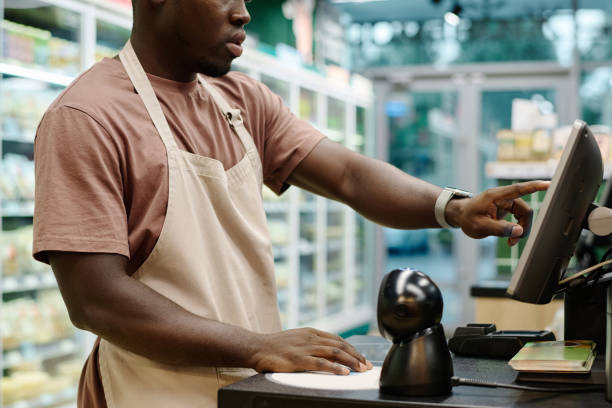istock Cashier working on computer in supermarket 1676367283