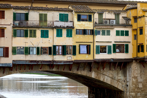 Florence, Italy - April 14, 2023: Detail of the iconic medieval Old Bridge, the Ponte Vecchio, which crosses the Arno River.